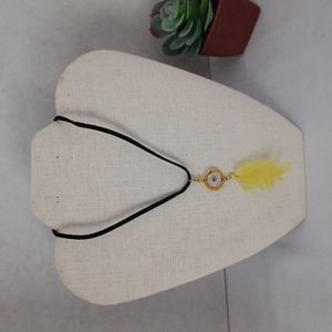 Dream catcher necklace, yellow feather.